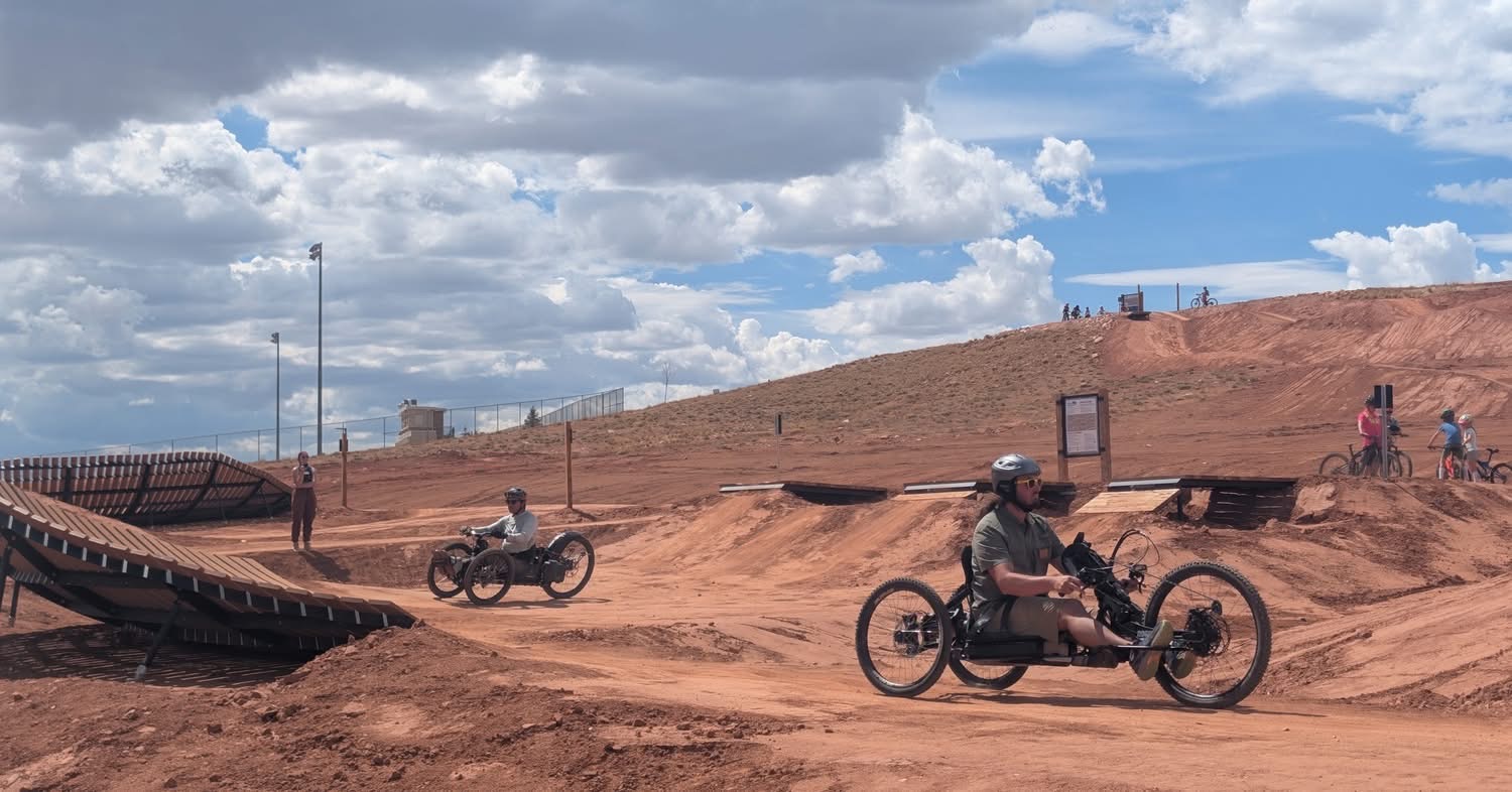 Adaptive riders testing the Laramie Bike Park pump track and jump lines