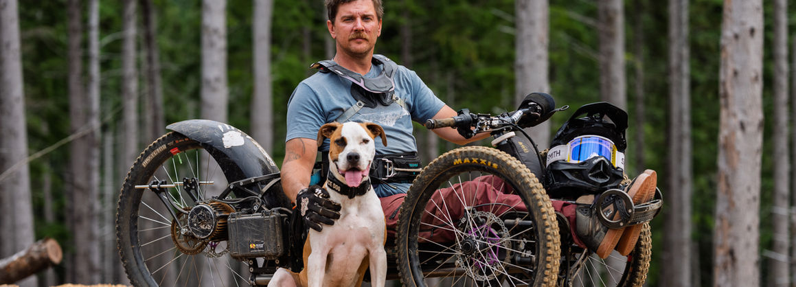 Joe Stone riding an adaptive mountain bike on a singletrack trail